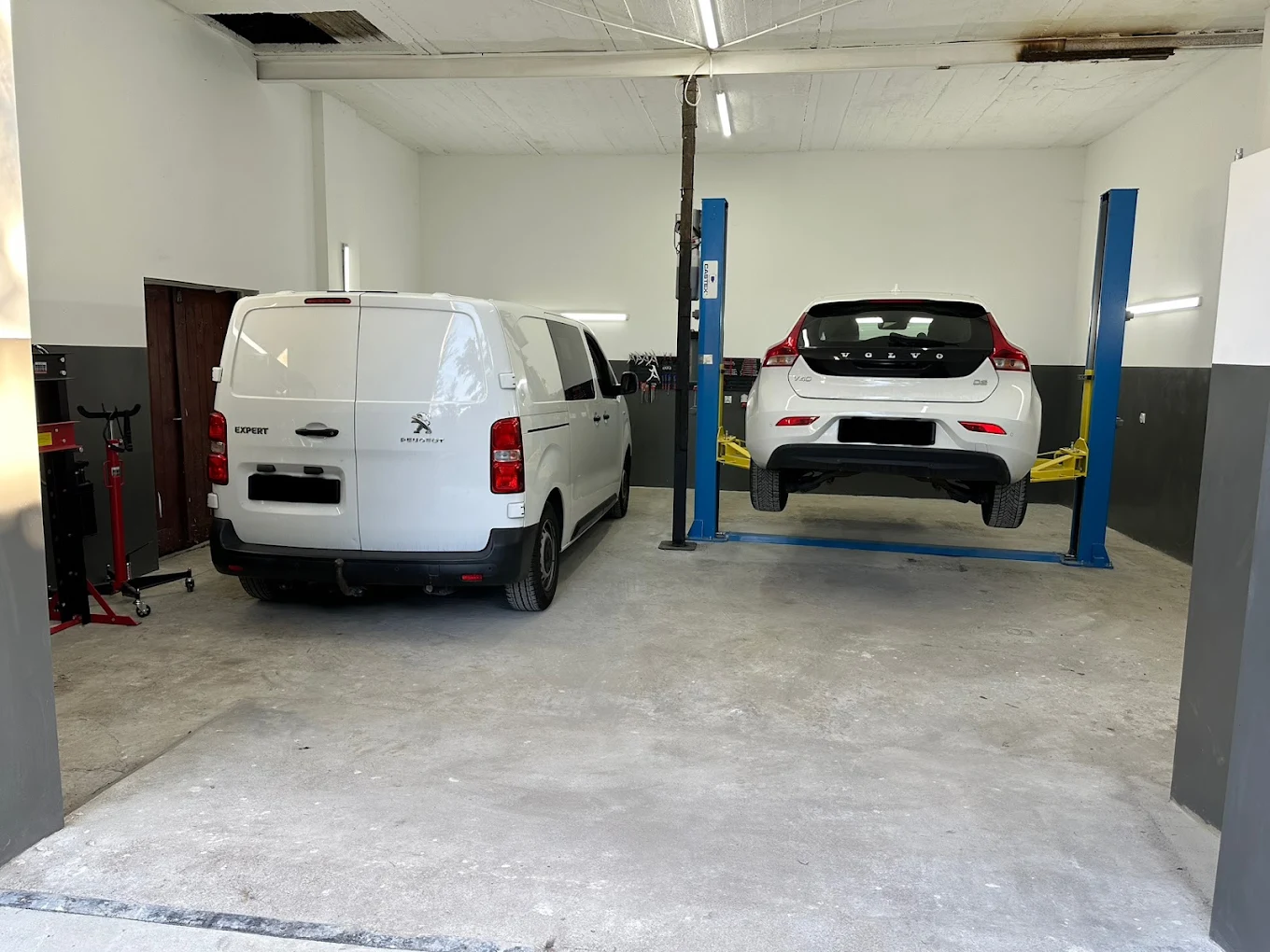 Hala warsztatowa Autoline Service Karpin z Peugeotem i Volvo przygotowywanymi do obsługi mechanicznej.